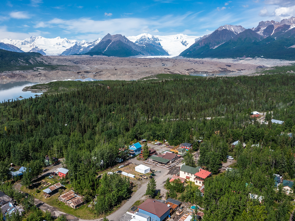 You peer over the trees in this apartment and see the view of Mountains & Glaciers all around