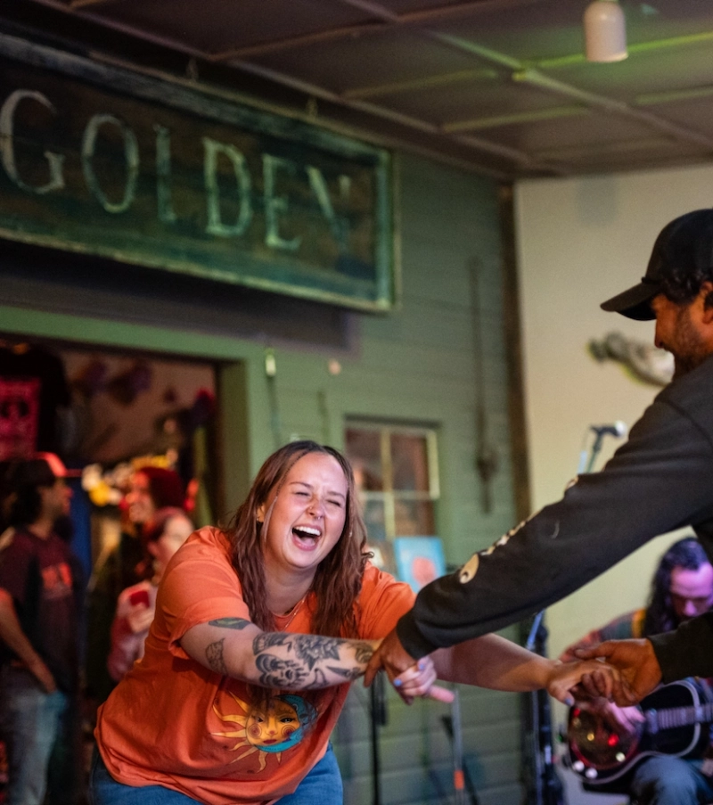 Two people dancing with joined hands