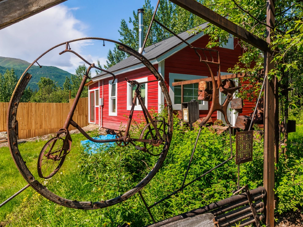 rustic metal sculpture on a sunny day with greenery